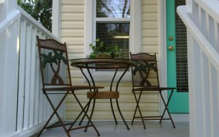 Front porch with cafe table and chairs - - Find pet friendly beach rentals in 30A Florida